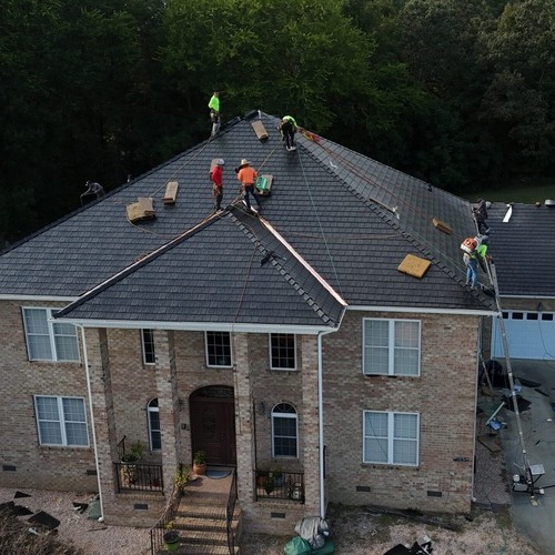 workers on a shingle roof