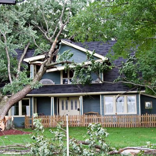 a home's roof damaged by storms